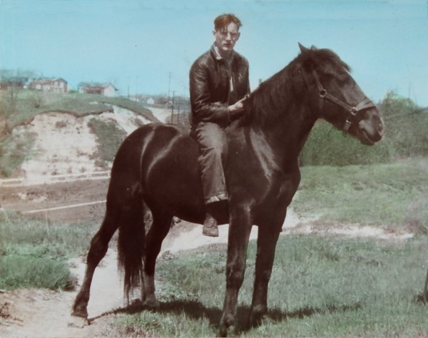 Photo of Ron on a black horse at the end of Blakley Avenue c. 1944